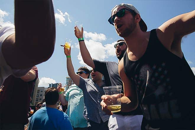 Guests celebrating aboard an open-air Honky Tonk Party Express bus in Nashville