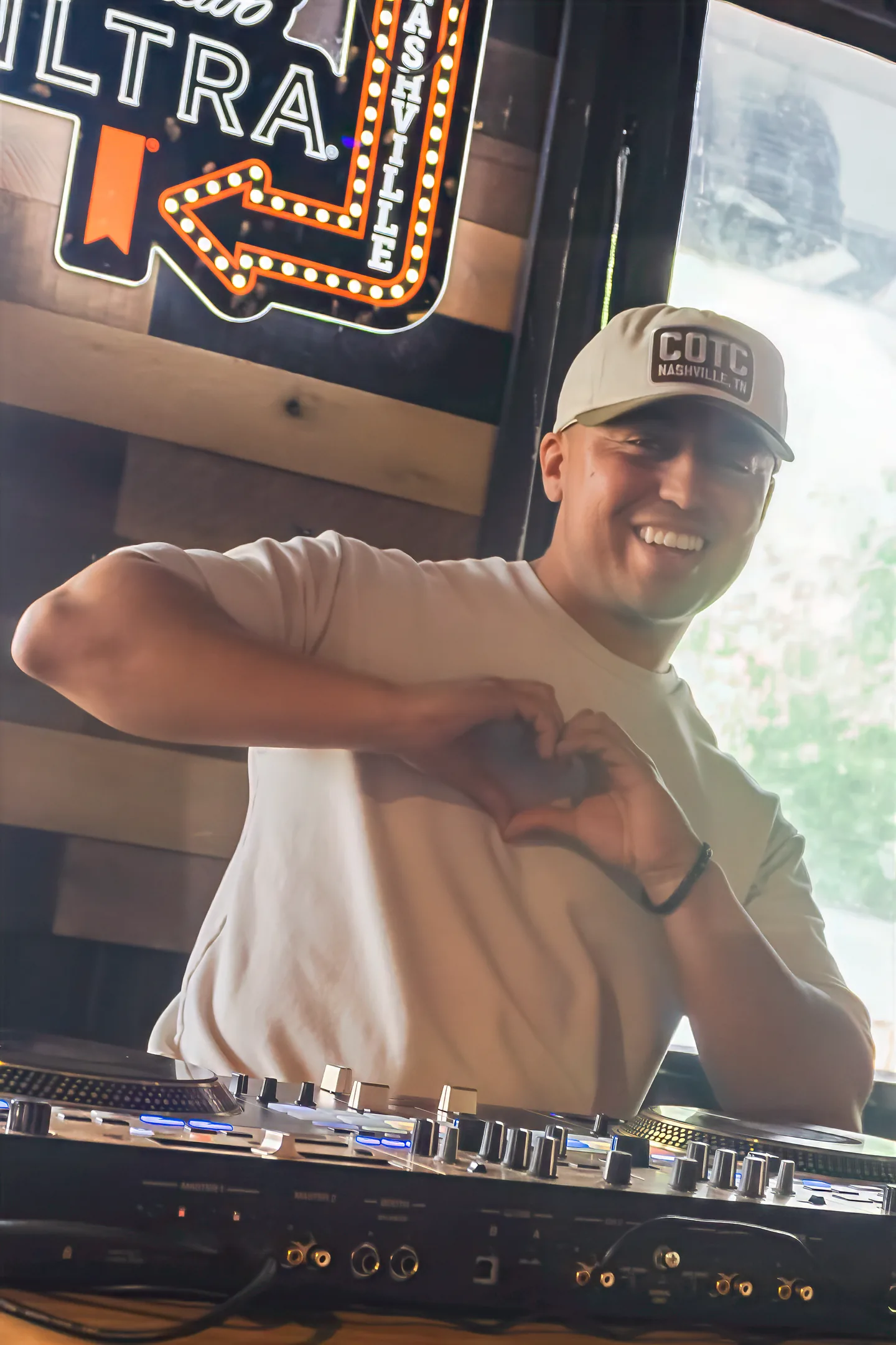 A DJ performing with a mixing controller at Honky Tonk Hideaway