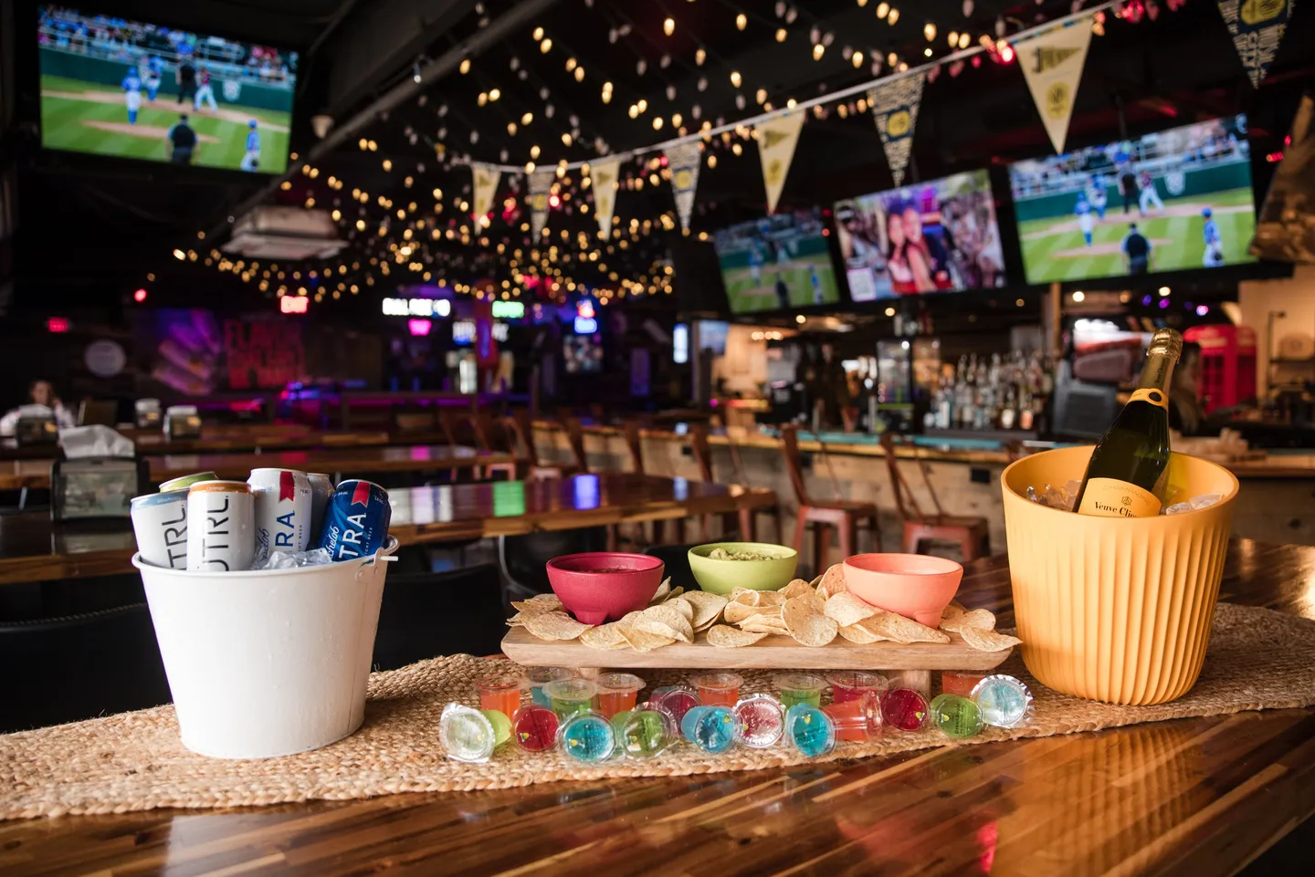 Chips, dips, drinks and shots on a group table at Honky Tonk Hideaway