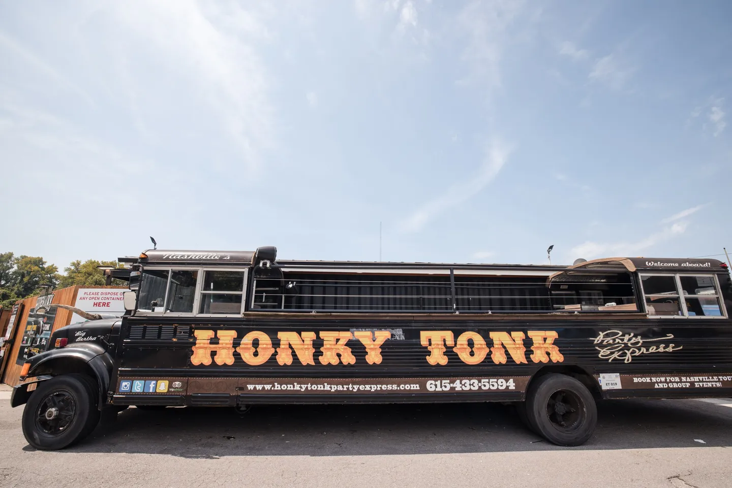 A black Honky Tonk party bus outside Honky Tonk Hideaway