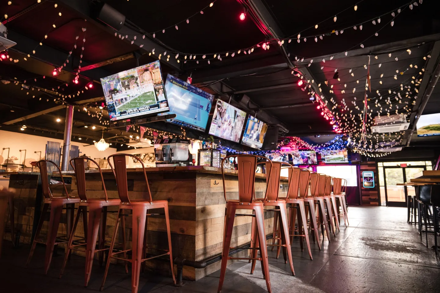 TV screens and bar seating inside Honky Tonk Hideaway