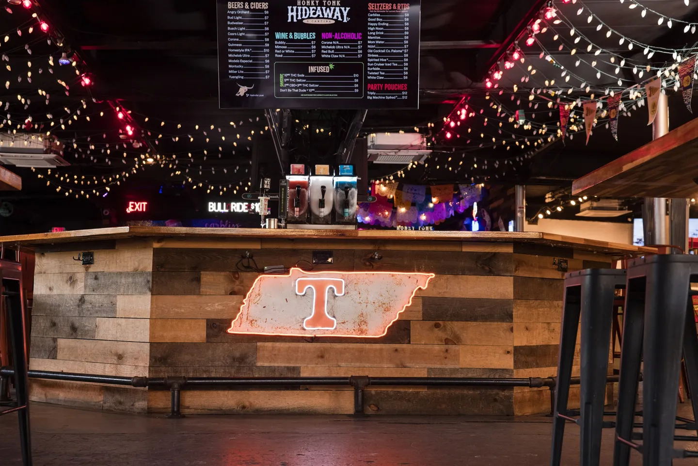 The Honky Tonk Hideaway bar with Tennessee branding and TV screens
